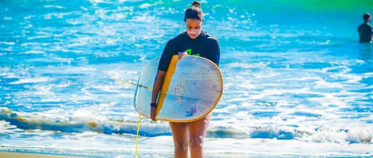 Laura Surfing in Costa Rica holding firewire surfboard